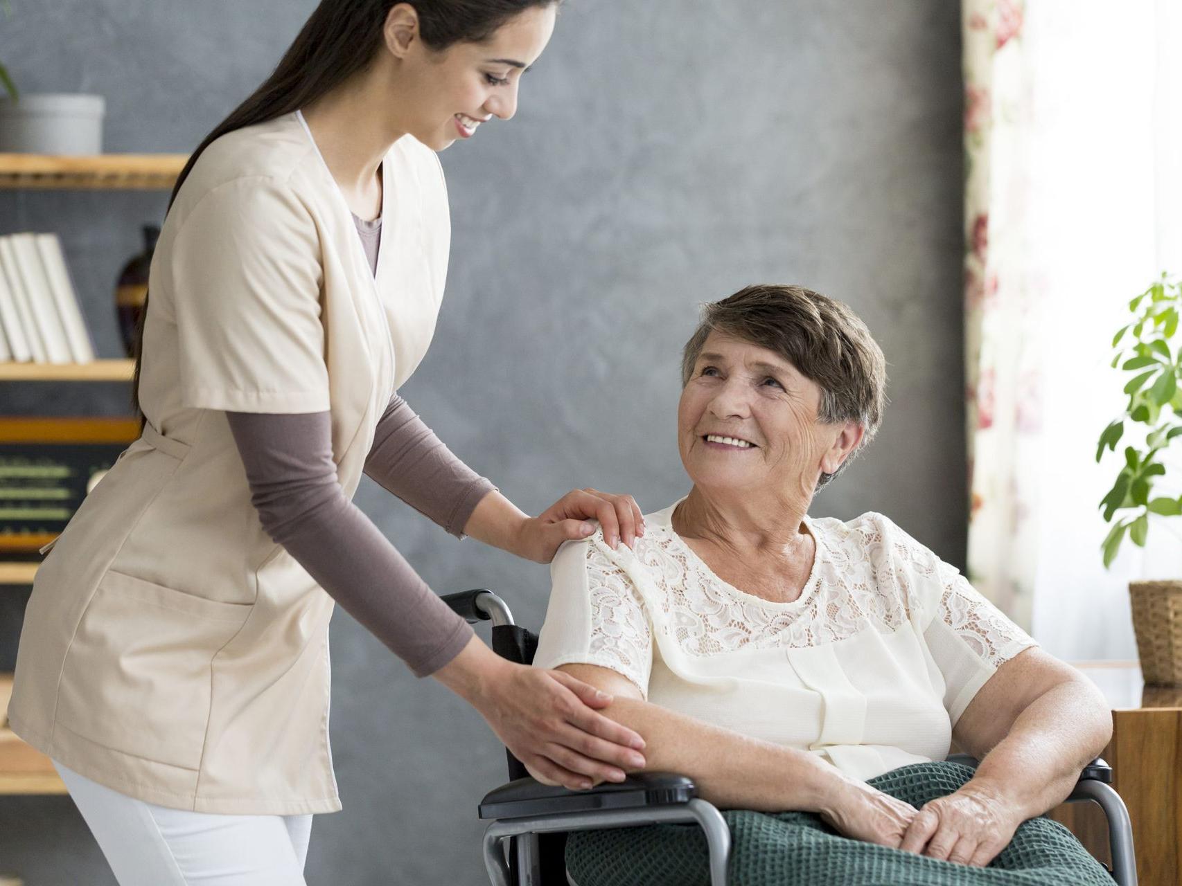 caregiver and patient in wheelchair