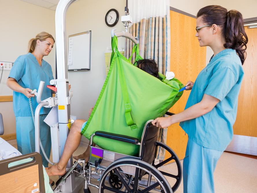 Caregiver Assisting a patient with a transfer