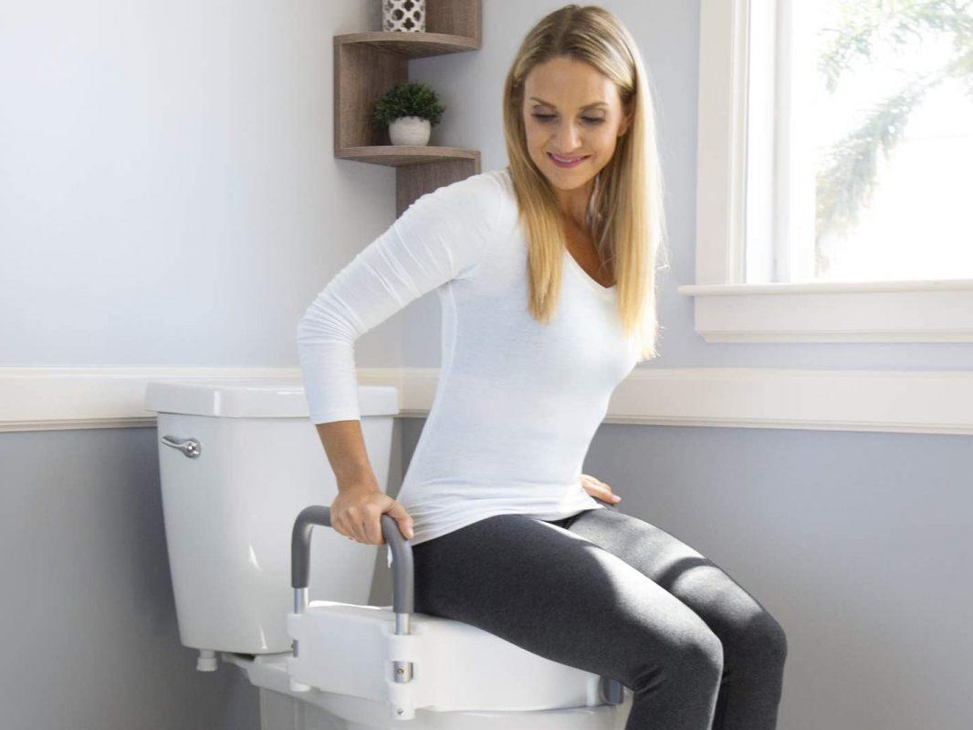 Woman on raised toilet seat